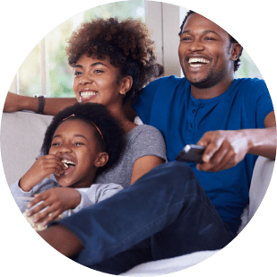 A family laughing on couch